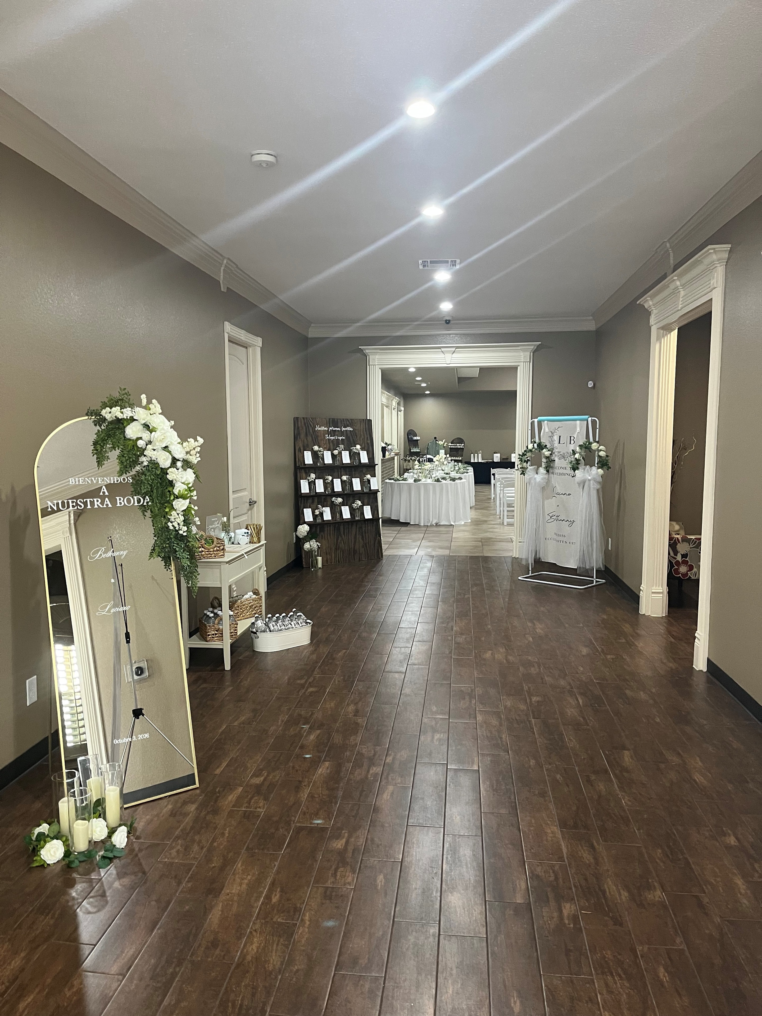 Elegantly decorated wedding foyer with floral arrangements and welcome signage